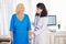 Physician helping senior woman