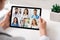 Physician Making Group Video Call With Colleagues Using Tablet Indoor