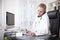 Physician Writing on Table While Talking on Phone