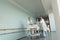 Physicians Rushing Patient On Gurney Down Hospital Corridor