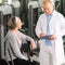 Physiotherapist assist active senior woman at gym