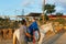 Physiotherapist doing exercises with a child with disabilities in an equine therapy session.