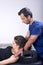 Physiotherapist doing a mobilization neck of female patient. Manual therapy. Neurological physical examination. Osteopathy,