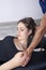 Physiotherapist doing a mobilization neck of female patient. Manual therapy. Neurological physical examination. Osteopathy,