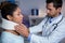 Physiotherapist examining a female patients neck