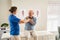 Physiotherapist helping senior man with his sore joint