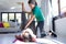 Physiotherapist helping to beautiful pregnant woman for doing pilates exercises with ball preparing for childbirth