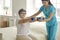 Physiotherapist or home care nurse helping senior woman do rehabilitation exercise