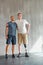 Physiotherapist, man with a disability and prosthetic leg and hug in physiotherapy, studio and gym. Male people, trainer