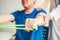 Physiotherapist man giving resistance band exercise treatment About Arm and Shoulder of athlete male patient Physical therapy