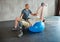 Physiotherapist, patient with disability or kettlebell or exercise ball at gym for recovery, people and healthcare