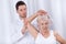 Physiotherapist rehabilitating elderly woman