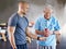 Physiotherapist, senior man patient and weight training for health and wellness therapy in retirement. Healthcare