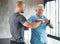 Physiotherapist, senior man and weight workout for health and wellness therapy in retirement. Healthcare, physio and