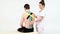 Physiotherapist sticks kinesio tapes to the back of patient, kinesiology taping, kinesiological therapy, athlete are