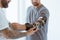 Physiotherapist who puts an orthosis on the hand of a young patient after an accident