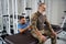 Physiotherapist working on the back of man in military clothing