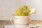 Phytotherapy, collecting medicinal useful herbs. Dried tansy flowers in a wooden mortar with pestle on a rustic background