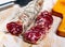 Piacenza salami cut in slices on a wooden surface, close-up