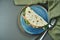 Piadina - classic Italian tortilla-bread with prosciutto, arugula, mozzarella and tomatoes on a blue plate on wooden table. Fast