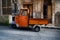 Piaggio Ape, light three-wheeled vehicle...Piaggio ape open backed van parked it Italian piazza...Piaggio Ape, three-wheeled light