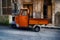 Piaggio Ape, light three-wheeled vehicle...Piaggio ape open backed van parked it Italian piazza...Piaggio Ape, three-wheeled light