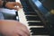 pianist man& x27;s hand playing piano. performer & classic music inst