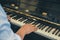 pianist man& x27;s hand playing piano. performer & classic music inst