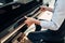 Pianist opens the keyboard lid of grand piano