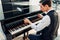 Pianist opens the keyboard lid of grand piano