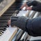 The pianist plays the piano outside in winter