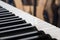 Piano keyboard closeup, blurry musical wallpaper like background