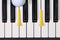 Piano keyboard and different golf balls and tees