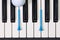 Piano keyboard and different golf balls and tees