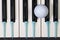 Piano keyboard and different golf balls and tees