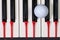Piano keyboard and different golf balls and tees