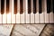 Piano keyboard with golden shine and sheet music top view