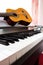 Piano keyboard with guitar and tambourine.