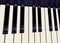 A piano keyboard is seen in a close up view with hints of blue in the dark keys. This is an illustration