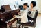 Piano lessons at music school, teacher and student.