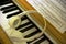 Piano light yellow wood keyboard with headphones and sheet music