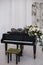 Piano with open keys decorated with a bouquet of white roses