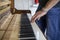 Piano tuner playing piano