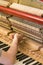 Piano tuning process. closeup of hand and tools of tuner working on grand piano. Detailed view of Upright Piano during a