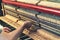 Piano tuning process. closeup of hand and tools of tuner working on grand piano. Detailed view of Upright Piano during a tuning.