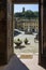 Piazza Buonaparte and the tower of Rocca Federico II framed by the door of the oratory of Saints Sebastian and Rocco, San Miniato