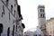 Piazza del comune di Assisi with the civic tower, the temple of Minerva and a geodesic dome with a reticular structure