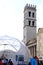 Piazza del comune di Assisi with the civic tower, the temple of Minerva and a geodesic dome with a reticular structure