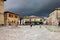 Piazza Roma in Monteriggioni medieval walled town, moments before an approaching large storm. Tuscany,