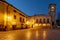 Piazza San Benedetto square in the historic center of Norcia, Italy, illuminated by evening lights